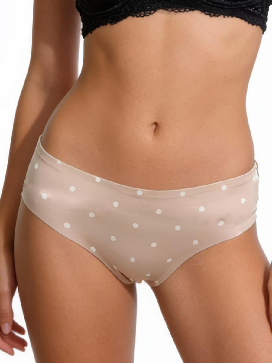 Beige polka dot underwear worn by a person on a white background