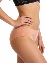 Person wearing peach-colored underwear on a white background