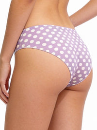 Purple polka dot bikini bottom on a plain background